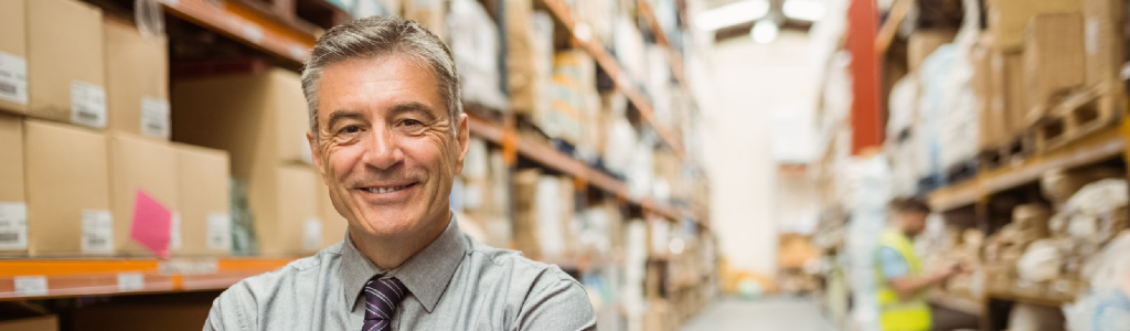 Man in shirt and tie in warehouse - lone worker safety