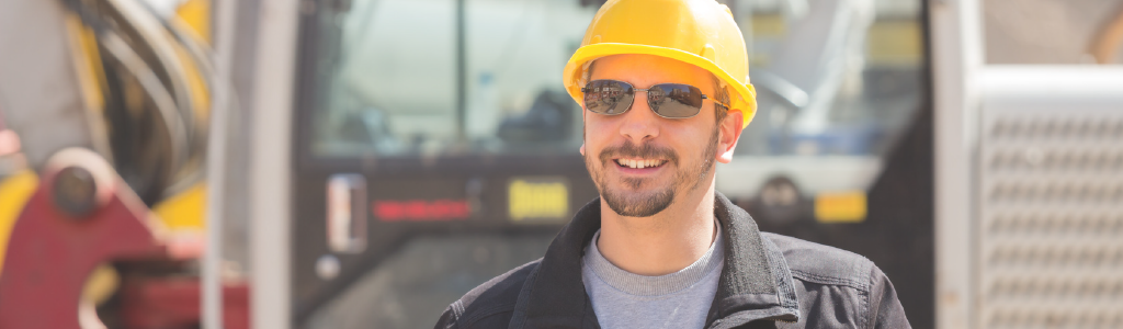 Worker outside, sun glasses, beware of the dangers of summer. IOSH Managing Safely. 