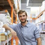 portrait of a smiling young warehouse worker working in a cash and carry wholesale store.